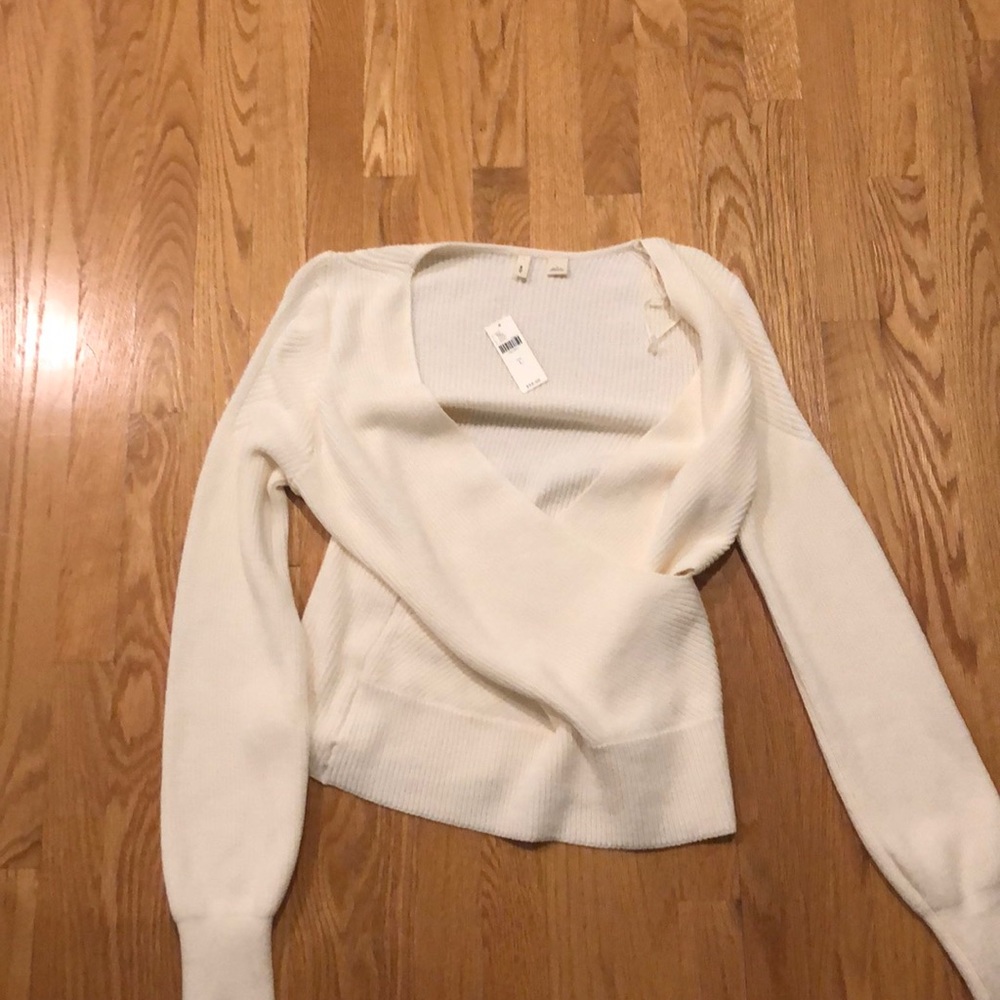 White sweater with cross in front
